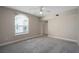 Bedroom featuring neutral walls and carpeting, a ceiling fan, and a large window at 206 E South St # 6007, Orlando, FL 32801