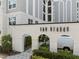 Beautiful building entrance to The Grande, featuring arched entryways and lush landscaping at 206 E South St # 6007, Orlando, FL 32801
