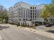 Elegant multi-story building exterior with architectural details, lush landscaping and private parking at 206 E South St # 6007, Orlando, FL 32801