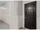 Condo front door with visible unit number and white wainscoting on the hallway walls at 206 E South St # 6007, Orlando, FL 32801