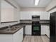 Functional kitchen with stainless steel appliances, sleek countertops, and white cabinetry at 206 E South St # 6007, Orlando, FL 32801
