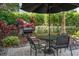 Private patio seating with table, chairs, umbrella and grill, surrounded by manicured landscaping at 206 E South St # 6007, Orlando, FL 32801