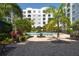Outdoor pool area featuring lounge chairs, tables, and landscaping for a resort-style living at 206 E South St # 6007, Orlando, FL 32801