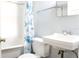 Bathroom with a bright tub, functional commode, and pedestal sink at 211 N Randolph Ave, Kissimmee, FL 34741