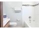 Bright bathroom featuring tiled shower, decorative accents, and functional commode at 211 N Randolph Ave, Kissimmee, FL 34741