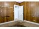 Empty bedroom featuring wood-paneled walls and a doorway leading to another room at 211 N Randolph Ave, Kissimmee, FL 34741