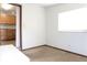 A view to the bedroom from the kitchen with carpet flooring and bright window at 211 N Randolph Ave, Kissimmee, FL 34741