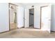 Cozy bedroom with carpet flooring, an open closet, and a view into the connecting bathroom at 211 N Randolph Ave, Kissimmee, FL 34741