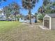 Exterior view of a well-maintained home with a lawn, shed, and palm tree at 211 N Randolph Ave, Kissimmee, FL 34741