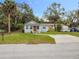 Inviting home with a well-maintained lawn and a long driveway, showcasing curb appeal and practicality at 211 N Randolph Ave, Kissimmee, FL 34741