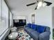 Bright living room featuring plush seating, large windows and unique ceiling fan at 211 N Randolph Ave, Kissimmee, FL 34741