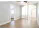 Bright living room with tiled floor, neutral paint and entryway to front door and side room at 211 N Randolph Ave, Kissimmee, FL 34741