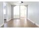 Bright living room features tiled floor, neutral paint and entryway to front door and side room at 211 N Randolph Ave, Kissimmee, FL 34741