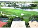Aerial view showcasing the community golf course, pool, clubhouse and well manicured lawns at 235 Promenade Cir, Lake Mary, FL 32746