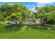 Backyard view to screened in pool with lush landscaping at 235 Promenade Cir, Lake Mary, FL 32746