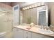 Bathroom with wallpaper, double vanity, and shower at 235 Promenade Cir, Lake Mary, FL 32746