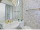 Bathroom features gold fixtures, a round mirror, and a glass-enclosed shower at 235 Promenade Cir, Lake Mary, FL 32746