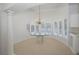 Elegant dining area with a glass table, chandelier, and large windows at 235 Promenade Cir, Lake Mary, FL 32746
