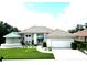 Exterior view of home with tile roof and attached garage at 235 Promenade Cir, Lake Mary, FL 32746