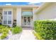Front entrance features covered awning, white trim, lush landscaping and stone walkway at 235 Promenade Cir, Lake Mary, FL 32746