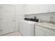Laundry room with white cabinets and stacked washer and dryer at 235 Promenade Cir, Lake Mary, FL 32746
