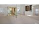 Spacious living room featuring neutral carpeting, built-in bar, and ample natural light at 235 Promenade Cir, Lake Mary, FL 32746