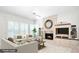 Comfortable living room with a fireplace, ceiling fan, and bright natural light at 235 Promenade Cir, Lake Mary, FL 32746