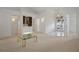 Bright living room featuring neutral carpet, wet bar, and unique glass front door allowing plenty of natural light at 235 Promenade Cir, Lake Mary, FL 32746