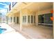 Covered patio with direct access to the pool area and offering multiple seating arrangements at 235 Promenade Cir, Lake Mary, FL 32746