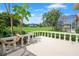 Covered outdoor patio overlooks meticulously maintained green lawn of the golf course at 235 Promenade Cir, Lake Mary, FL 32746