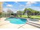Screened-in pool with integrated spa and lush landscaping offers a private outdoor retreat at 235 Promenade Cir, Lake Mary, FL 32746