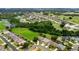 Aerial photograph featuring homes near green spaces, golf course, and a scenic waterway at 2681 Cabernet Cir, Ocoee, FL 34761