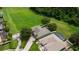 Overhead view features a well-kept yard with pool and car on drive, adjacent to open greenery with tree coverage at 2681 Cabernet Cir, Ocoee, FL 34761