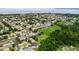 Aerial image showing the community with lush trees, green spaces and a tranquil lake in the distance at 2681 Cabernet Cir, Ocoee, FL 34761