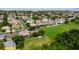 An aerial view of a lush residential community with well-maintained lawns and houses near a vast, scenic green space at 2681 Cabernet Cir, Ocoee, FL 34761