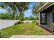 Well-maintained backyard features a white fence, lush greenery, and a playset at 2681 Cabernet Cir, Ocoee, FL 34761
