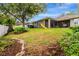 Wide shot of backyard featuring playset, lush lawn, and a screened-in patio at 2681 Cabernet Cir, Ocoee, FL 34761