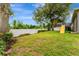 Spacious backyard with a playground, mature trees, and a white privacy fence at 2681 Cabernet Cir, Ocoee, FL 34761
