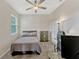 Neutral bedroom features a ceiling fan, carpeted floors, closet, a dresser, and a twin bed at 2681 Cabernet Cir, Ocoee, FL 34761