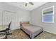 Neutral bedroom features a ceiling fan, carpeted floors, closet, desk, and a twin bed at 2681 Cabernet Cir, Ocoee, FL 34761