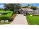 Beautiful home exterior with a well-manicured lawn, a brick-paved driveway, and mature trees at 2681 Cabernet Cir, Ocoee, FL 34761