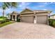 Charming single-story home with a paved driveway and three-car garage at 2681 Cabernet Cir, Ocoee, FL 34761