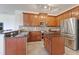 Kitchen with stainless steel appliances, wood cabinetry and granite countertops at 2681 Cabernet Cir, Ocoee, FL 34761