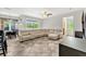 Open floorplan living room with tile flooring, modern furniture, and abundant natural light at 2681 Cabernet Cir, Ocoee, FL 34761