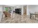Open-concept living room features neutral tones and access to a screened patio at 2681 Cabernet Cir, Ocoee, FL 34761
