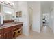 Bright main bathroom vanity with walk-in closet and views into the bathroom at 2681 Cabernet Cir, Ocoee, FL 34761