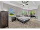 Spacious main bedroom with tray ceiling, carpet, and large windows with views at 2681 Cabernet Cir, Ocoee, FL 34761