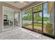 Relaxing screened patio with tile flooring and views of the backyard and office at 2681 Cabernet Cir, Ocoee, FL 34761