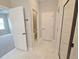 Well-lit bathroom featuring a walk-in shower and view of a room with gray carpet at 2699 Sw 161St Loop, Ocala, FL 34473