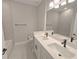 Bathroom featuring dual sinks with matte black hardware, neutral paint, and tub at 2699 Sw 161St Loop, Ocala, FL 34473